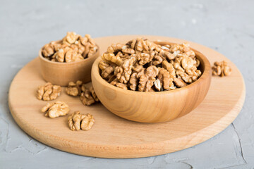 Fresh healthy walnuts in bowl on colored table background. Top view Healthy eating bertholletia concept. Super foods