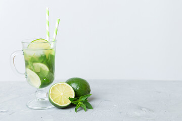 Mojito summer refreshing cocktail with ice and mint. mojito cocktail with lime, lemon and mint in a tall glass with a stick