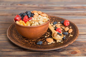 Cooking a wholesome breakfast. Granola with Various dried fruits and nuts in a bowl. The concept of a healthy dessert. Flat lay, top view with copy space