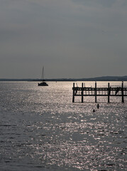 boat and pier in late day sun (sunset light) seascape, hudson river, ocean
