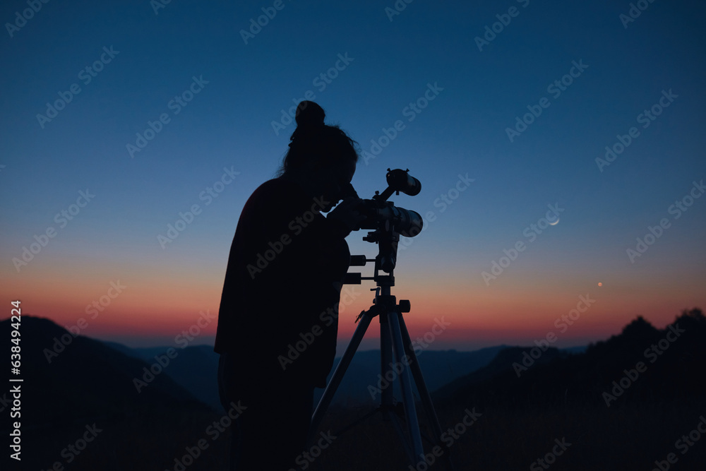 Canvas Prints astronomer looking at the starry skies and crescent moon with a telescope.