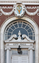 Fototapeta na wymiar city hall building entrance detail (in burlington vermont) deer head, door, light, lantern, window sign