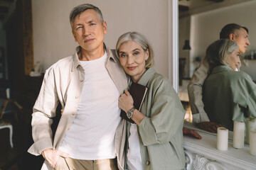 Fototapeta premium Senior couple standing near mirror at home