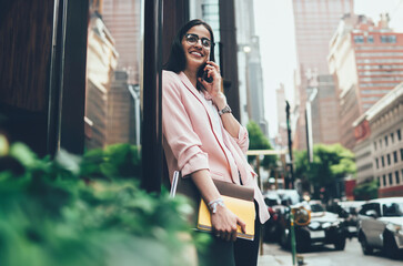 Fototapeta premium Happy businesswoman talking on phone in city