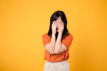Sad young woman isolated on yellow background, reflecting inner confusion and anxiety. Expressive portrait of upset emotions concept.