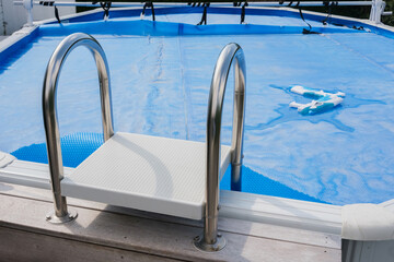 Ladder to go up to a portable pool, refreshing in summer.
