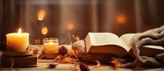 Obraz na płótnie Canvas Cozy concept for autumn or winter with books candles and relaxation
