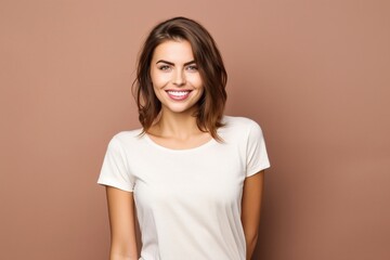 Obraz premium young attractive female wearing white tshirt for mock up on beige background