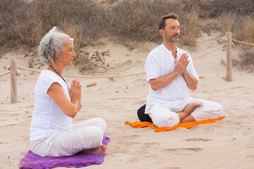 Practicing kundalini yoga on the beach