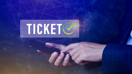 Businessman holding smartphone with button Ticket word, Business, Technology, internet and networking concept businessman pressing online booking button on virtual screens.