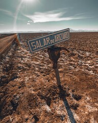 sky in the high lands in argentina, salar de arizaro and the salt flats with an old billboard
