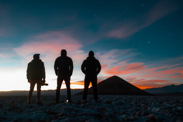 sunset in the high lands in argentina, salar de arizaro and the cono de arita, the most hight and perfect natural pyramid in the world, with the sky full of stars and the galaxy at sight