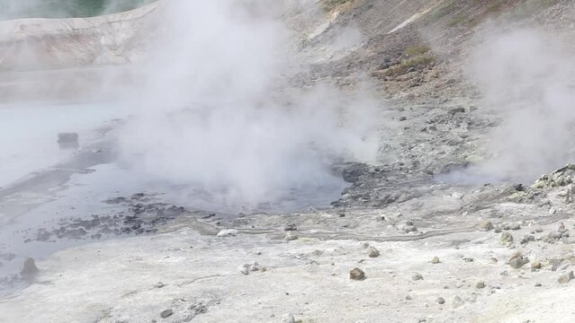 steaming hydrothermal outlet on the shore of the hot lake in the caldera of the Golovnin volcano on the island of Kunashir