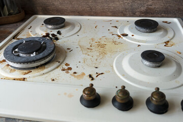 dirty stove close up in the kitchen. concept of life, household routine, lack of time, dirty kitchen after cooking