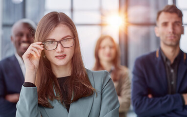 Portrait of a confident young businesswoman standing with her arms crossed in an office