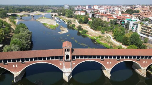Europe, Italy , Pavia - Drone aerial view of Pavia City in Lombardy with Ponte Coperto (  covered bridge ) on the Ticino and Po' river and during drought and summer aridity 