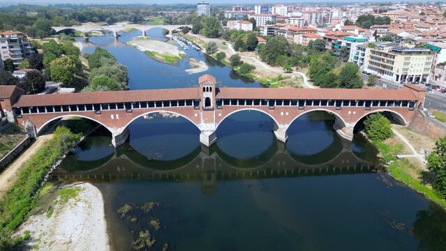 Europe, Italy , Pavia - Drone aerial view of Pavia City in Lombardy with Ponte Coperto (  covered bridge ) on the Ticino and Po' river and during drought and summer aridity 