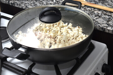 woman cooking popcorn at home to watch a movie