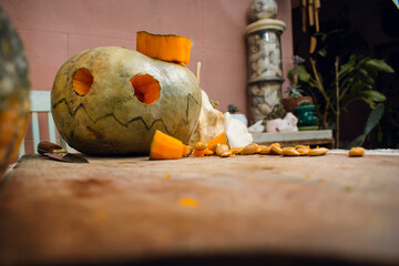 front view of homemade halloween pumpkin on wooden cutting board, copy space.