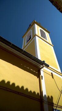 Beautiful bell tower painted on yellow, in Bell&uacute;s, Valencia (Spain)