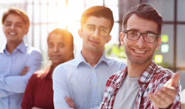 Welcome on board. Portrait of positive confident millennial male hr manager leader of multiethnic team