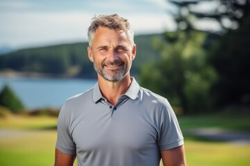 Portrait of smiling man standing in golf course on a sunny day