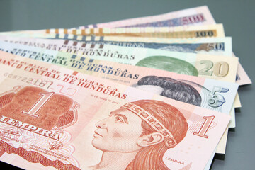 Honduran money, Currency of Honduras. Lempira bills on dark background. Varius Hondurian bills of different denomination - obrazy, fototapety, plakaty