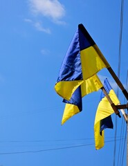 National flag of Ukraine against blue sky. National flags of Ukraine on outdoors