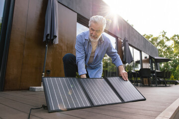 Caucasian man with solar panel innovation technology alternative energy.