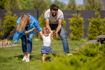Fototapeta premium Young parents with a little cute boy in the park