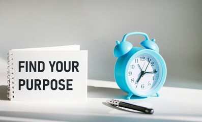 Text message Find your goal on notepad with alarm clock and pen