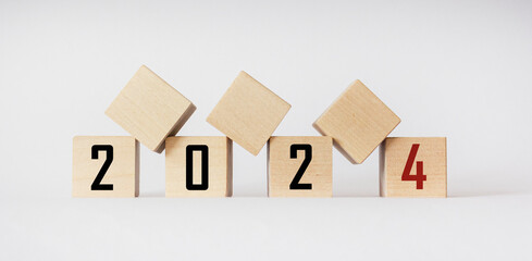 Wooden blocks of 2024 on a white background. Start new year 2024 with goals plan, goal concept, action plan, strategy, new year business vision.