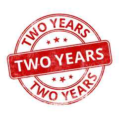 ‘Two Years’ circular red rubber stamp seal with distressed texture isolated on transparent background