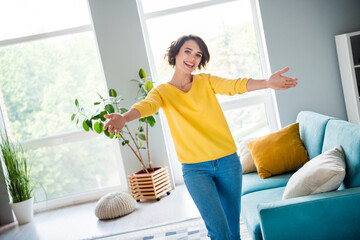 Photo of positive lady realtor invite people buying new house welcome hug with open hands indoors...