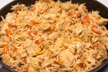 Tasty pilaf with chicken as background.