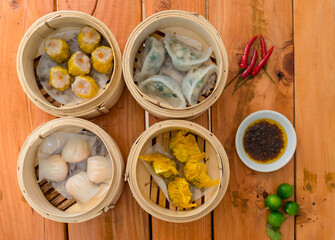 Top view of various Dim sum - Shumai,Shark fin, Shrimp and Chive, and Hargow. Served with chili oil and calamansi.