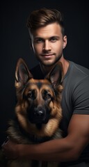 Portrait of a handsome young man with his dog on black background