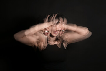 Stroboscopic photo of shouting young woman on dark background