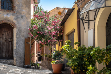 View of a beautiful town of Castelmola in Sicily. Architecture of buildings with planted plants outside