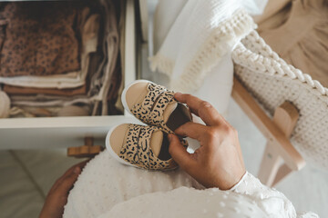 Pregnant woman is getting ready for the maternity hospital, packing baby stuff. pregnant woman preparing and planning baby clothes