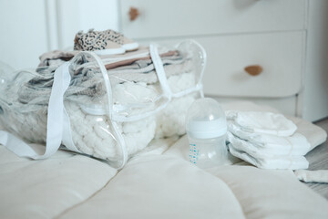 Fototapeta na wymiar Bag with things to the maternity hospital, the concept of motherhood and expectation of a baby