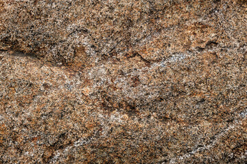 Close-up beautiful abstract beige marble background with dark spots.