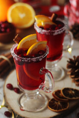 Glasses with warm cranberry with oranges drinks