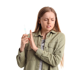 Young female junkie rejecting syringe with drugs on white background