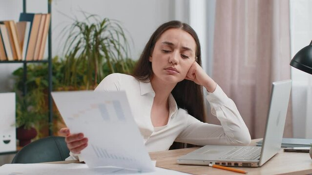 Bored sleepy Caucasian business woman worker working on laptop computer yawning leaning on hand falling asleep at office. Exhausted tired freelancer workaholic girl. Employment, occupation, workless