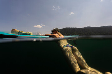 An underwater image of a woman cooling off in an alpine lake during a hot summer in Oregon.