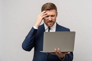 Frustrated businessman in emotional stress watching downfall stock market on laptop, lost money on...