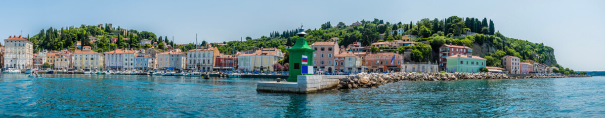 Fototapeta na wymiar A panorama view across the entrance to the outer harbour in the town of Piran, Slovenia in summertime
