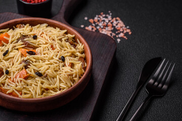 Delicious Uzbek pilaf with chicken, carrots, barberry, spices and herbs