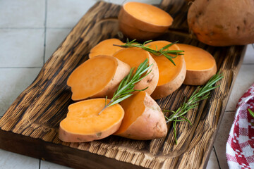 raw sliced sweet potato on old background